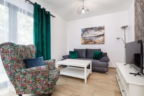 Relax in the stylish living room with a comfortable sofa and cosy decor.