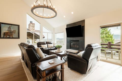 Bright living room with cozy seating and large windows.
