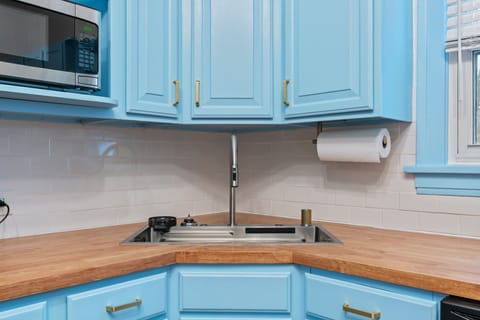 Modern sink with pull out faucet, waterfall spout, and cup rinser
