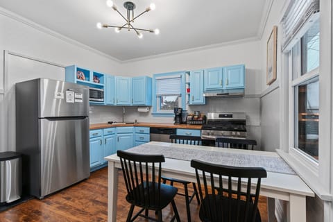 Kitchen includes stainless steel appliances, dining table for 4, & high chair