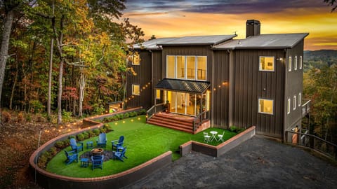 As the sun sinks behind the ridges, the home glows with a golden warmth that welcomes you in.