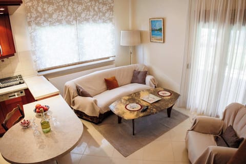 Bright, airy living area with stylish seating and large windows that fill the room with natural light.