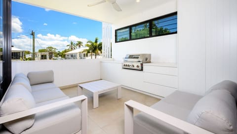 Relaxing outdoor lounge with leafy district views—perfect for unwinding.