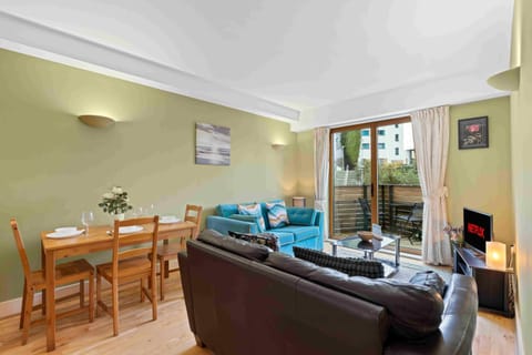 Open-plan living room with modern kitchen, comfortable seating and a bright, contemporary finish
