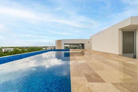 Relax by the rooftop pool with sunset vibes.