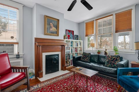 Spacious living room with historic fireplace and a smart TV