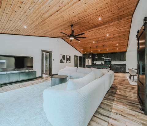 Open living area with Smart TV, large sectional, and lake views 