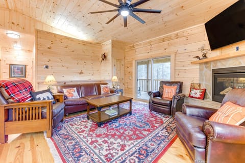 Living Area | Open-Concept Great Room with Fireplace and TV