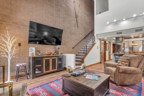 Living room: Plush seating, gas fireplace, vaulted ceiling, rustic decor
