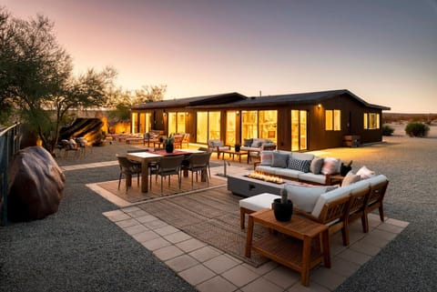 Glowing at golden hour, with outdoor living space that blurs the line between inside and out.