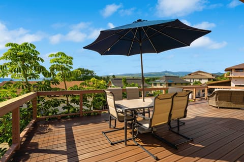 The private deck at Hale O'Kapeka has ocean views, mountain backdrop, and seating for the whole group.