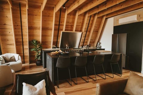 Warm wood tones and modern design! This inviting kitchen is perfect for cozy gatherings or culinary adventures