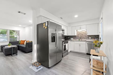 Open kitchen with stainless steel appliances and modern finishes.