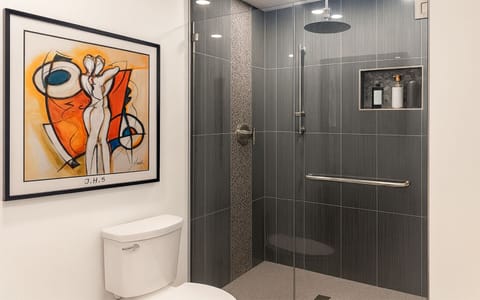 Full shared bathroom with spacious walk-in shower and modern tile, used only by guests in The Gold Room and the on-site hosts at Garden of Manors.
