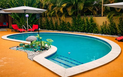 Heated, clothing-optional, saltwather pool surrounded by lush tropical landscaping.