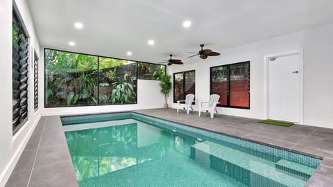 Indoor pool area surrounded by lush tropical views