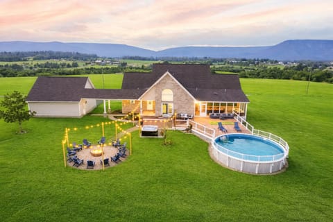 Firepit lit, pool shimmering, hot tub glowing, mountains going forever. 