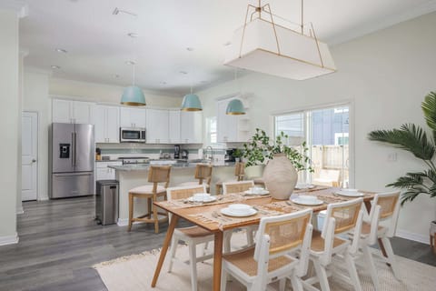 "Whip up snacks or cocktails in a bright kitchen featuring turquoise pendants, granite counters and a window overlooking the pool. A gorgeous backdrop for any meal. - The Coquina - St. Augustine, FL"
