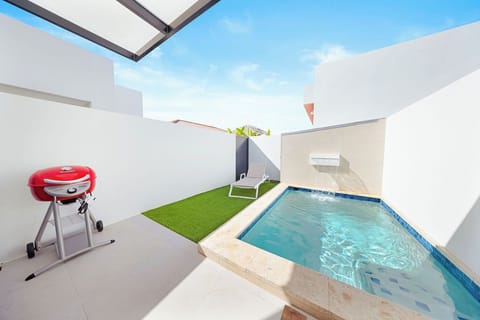 Sun, Soak, and Sizzle! We've got the three essentials for a perfect vacation right here: A dipping pool to cool off, a comfy lounge chair to dry off, and a BBQ grill to feed off.