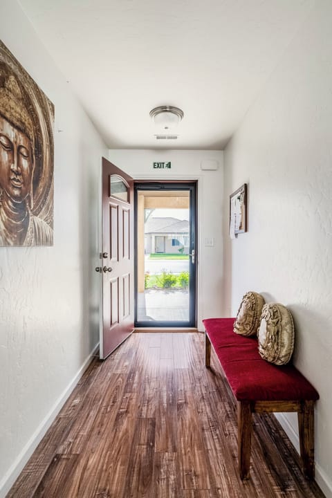 Welcoming entryway where warm wood floors meet thoughtful touches.