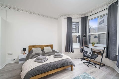 Cozy bedroom with a comfortable bed and a side working table for productivity.
D3 Short Stays