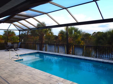 Private Pool with Canal Views, Florida Palms & Full Screen Enclosure