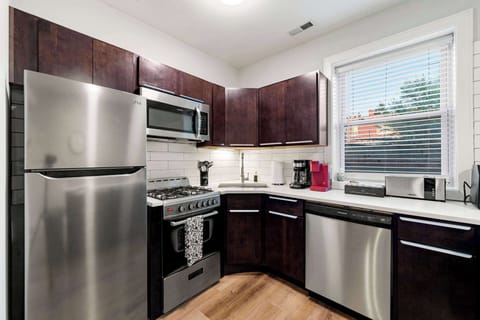 Sleek kitchen ready for quick meals & long chats.