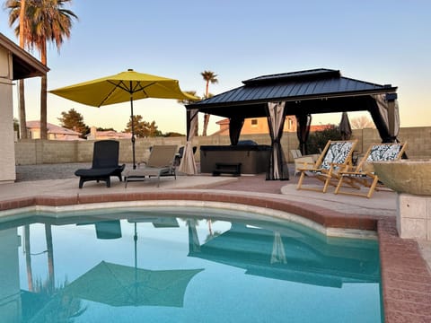 relax by the pool or under the gazebo with hot tub and seating