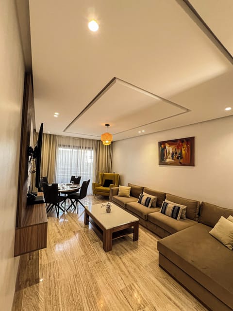 Relax in a bright, cozy living area with natural light and a large Smart TV.