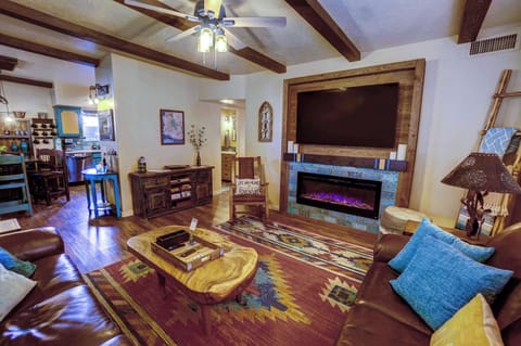 cozy living room, large smart TV and electric gas fireplace