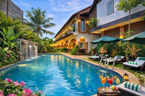 Indoor pool, open 8:00 AM to 9:00 PM, pool umbrellas