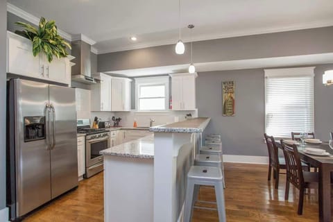 Kitchen: Sun-filled and social! The kitchen flows seamlessly into the dining space, creating a welcoming atmosphere for gatherings.