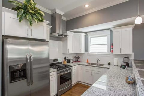 Kitchen: Sun-filled and social! The kitchen flows seamlessly into the dining space, creating a welcoming atmosphere for gatherings.