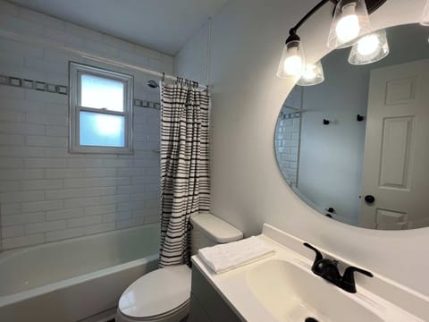Full Bathroom: The bathroom offers ample space and includes a toilet, vanity area, and shower with a bathtub.
