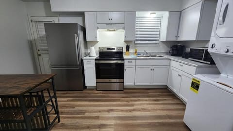Kitchen: Our spacious kitchen is equipped with ample counter space, storage, stainless steel appliances, and an island table.