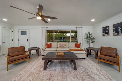 Beautifully styled living room with plenty of cozy seating, smart TV, and ceiling fan