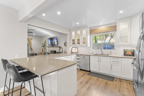 Open-concept kitchen with stainless appliances and generous counter space.