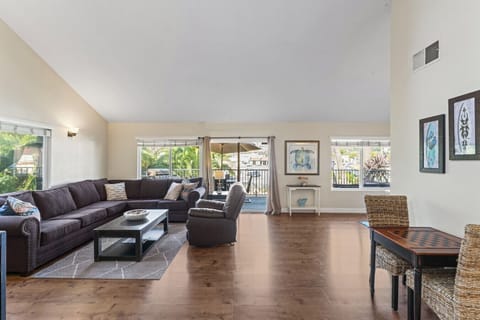 Bright living area w/ comfy seating, wood floors & large windows letting in natural light