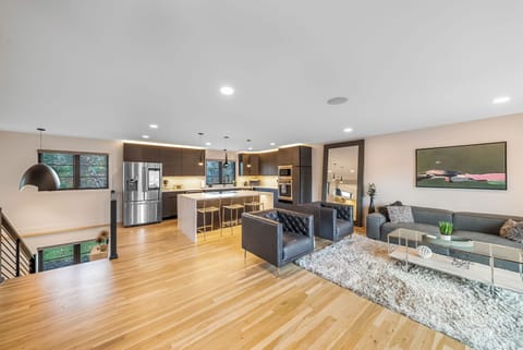 Relax in this stunning open-concept space where your modern kitchen flows seamlessly into a cozy living area with sleek furnishings.