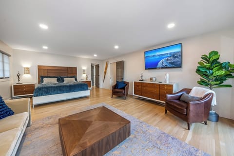 Sink into your spacious suite with warm wood tones, leather seating, and a large TV for cozy evenings after exploring.