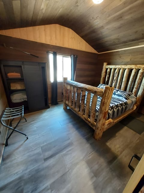 Unwind in a rustic log bed beneath warm wood ceilings.