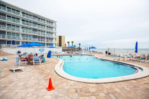 Relax by the sparkling pool with ocean views, perfect for enjoying a sunny afternoon at Sea Club IV Resort.