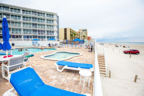 A picturesque view from the poolside, showcasing the beautiful beach and inviting atmosphere of Sea Club IV Resort.