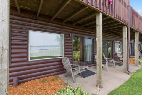 Covered patio with seating, offering a shaded retreat and views of the lake.