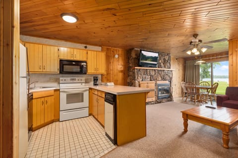 Fully equipped kitchen with wood cabinetry, modern appliances, and open layout.