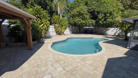 Open-air pool, shade, seating and a gazebo. 