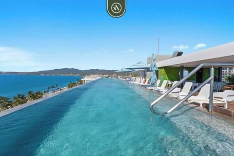 Stunning rooftop infinity pool with panoramic ocean views, perfect for swimming, sunbathing, and enjoying unforgettable sunsets.