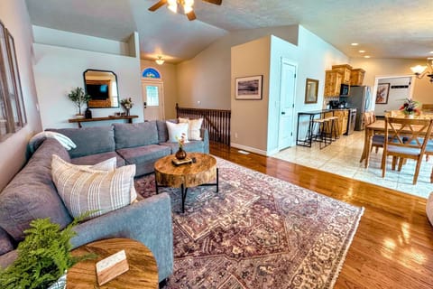 The spacious open-concept living area with cozy seating, a gas fireplace, and seamless flow leads straight to the dining room and kitchen.