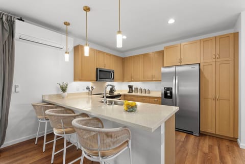 Additional barstool seating at the kitchen counter.