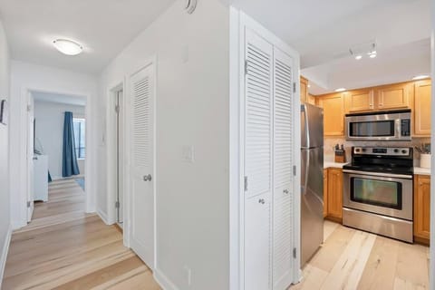 Open kitchen w/ warm wood cabinets & everything within reach.